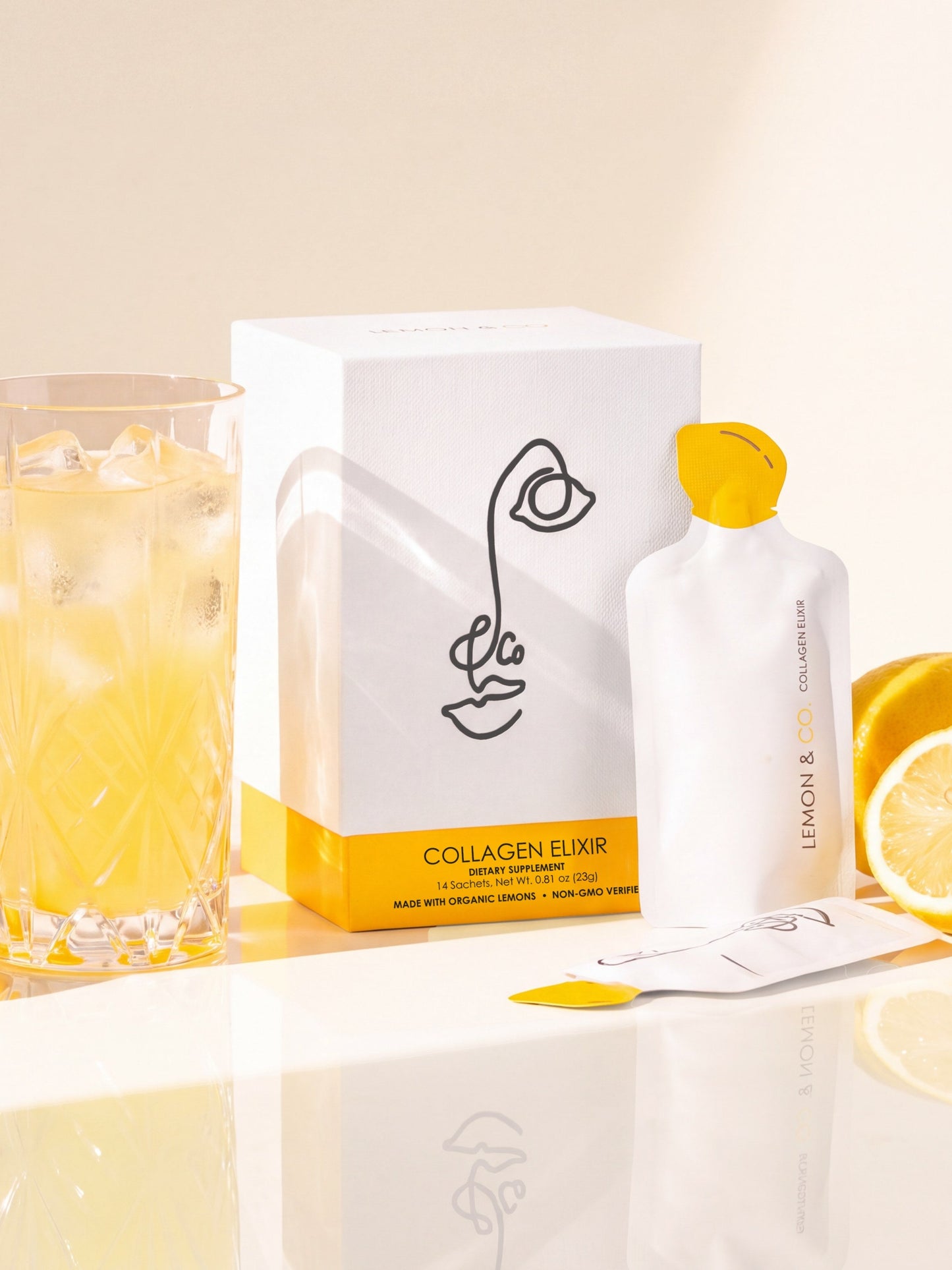 Lemon & Co. Liquid Collagen Elixir carton with a sachet and a glass of lemonade